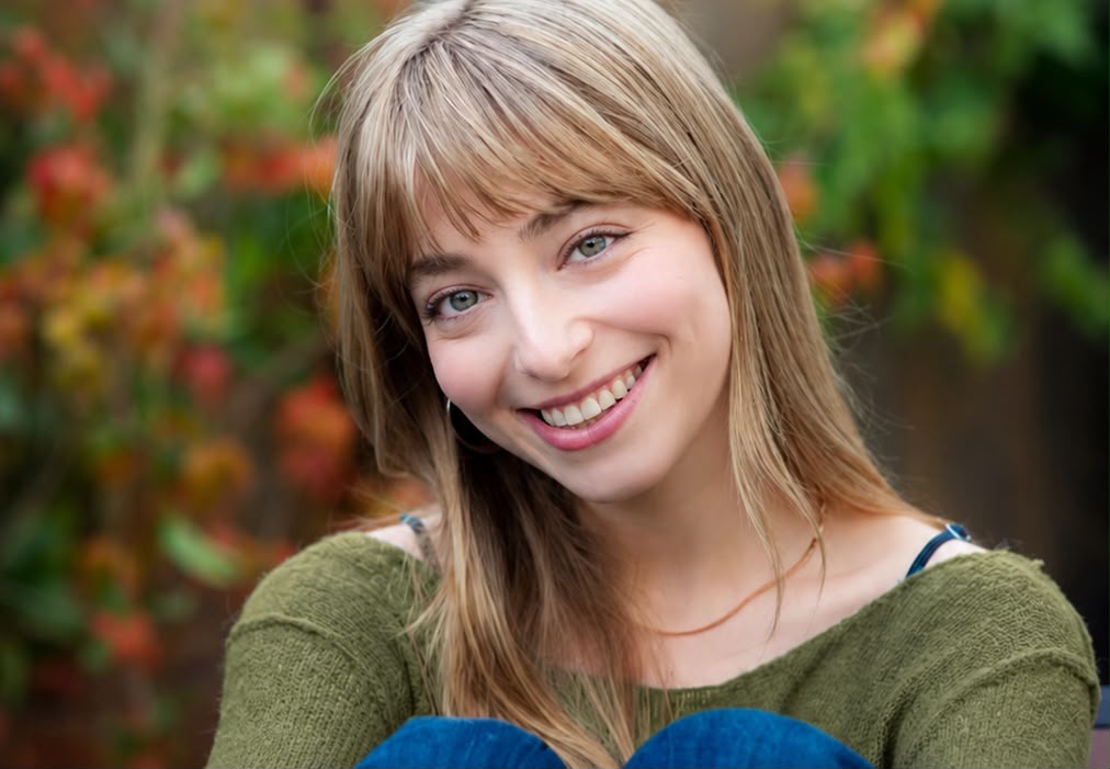 Lee Kedem smiling, autumn foliage background
